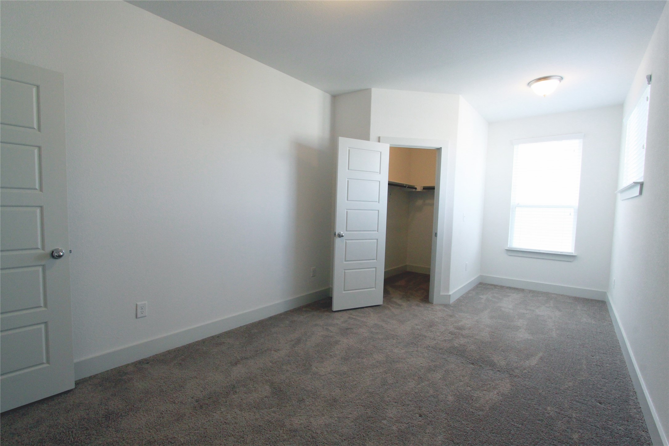 1507 Homespun Road Austin, TX 78745 - Photo 29 of 35 Carpeted room with white walls, a single window, and a built-in closet with shelving