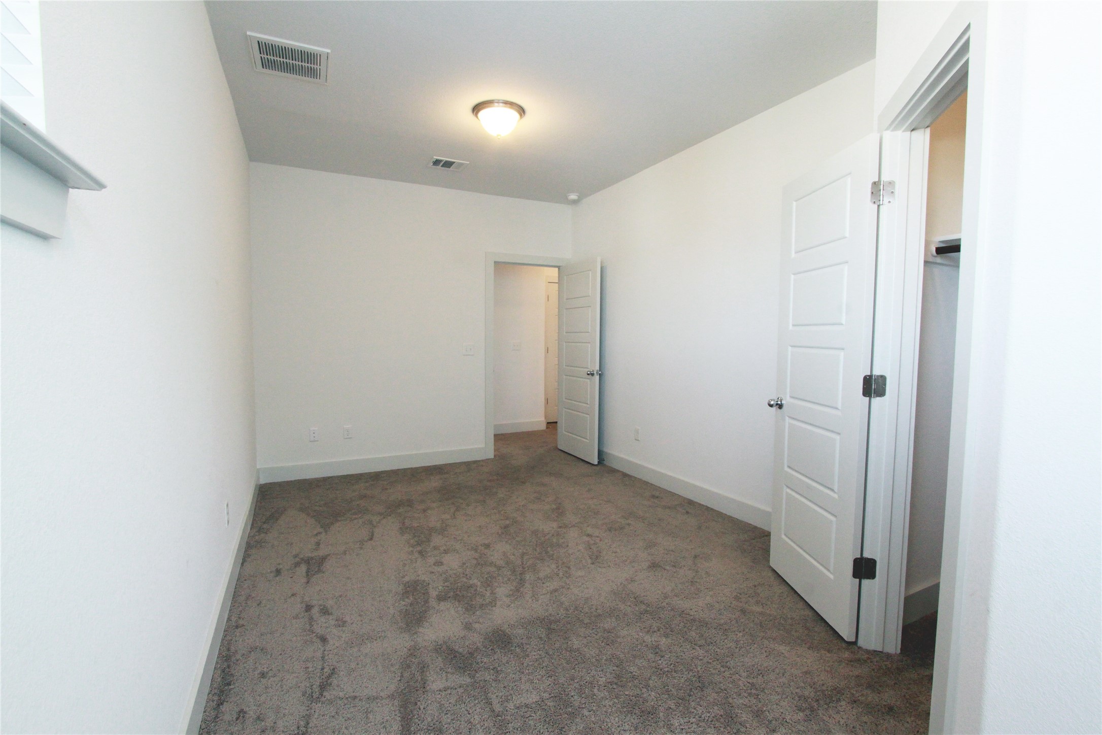 1507 Homespun Road Austin, TX 78745 - Photo 30 of 35 Carpeted room featuring white walls, white trim, and a contemporary ceiling light fixture