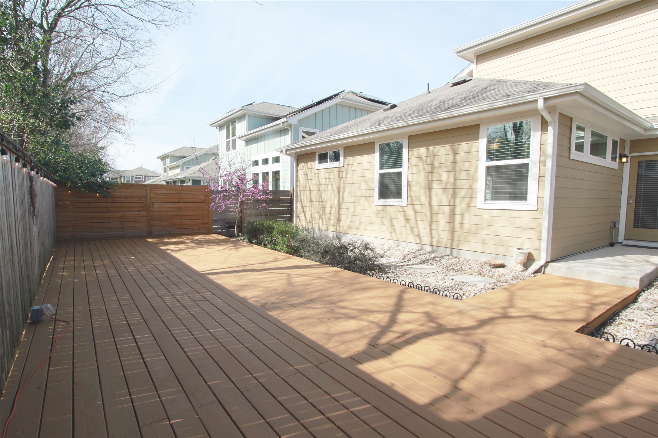 1507 Homespun Road Austin, TX 78745 - Photo 33 of 35 Expansive outdoor deck featuring wood-finish flooring, a wood privacy fence, and a concrete patio