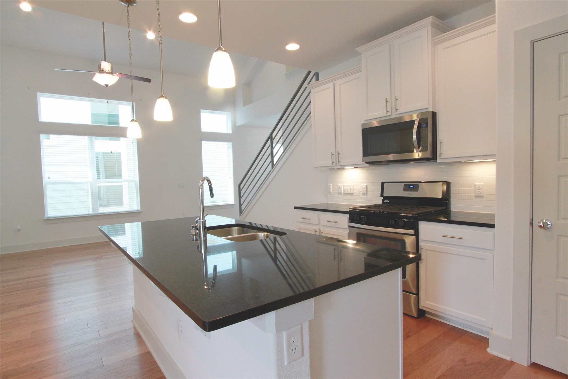 1507 Homespun Road Austin, TX 78745 - Photo 10 of 35 Modern kitchen island with an undermount sink and dark countertop