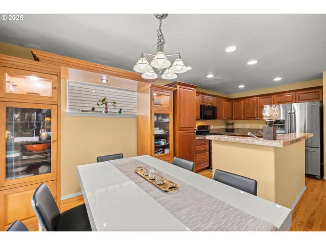 a living room with kitchen island granite countertop furniture and a large window