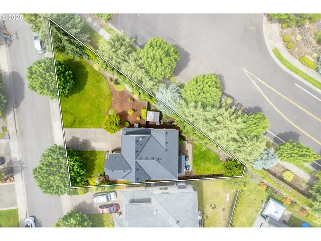 an aerial view of a house with a yard swimming pool and outdoor seating