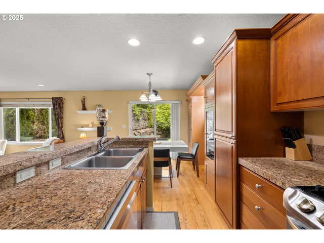 a kitchen with granite countertop a sink and a stove