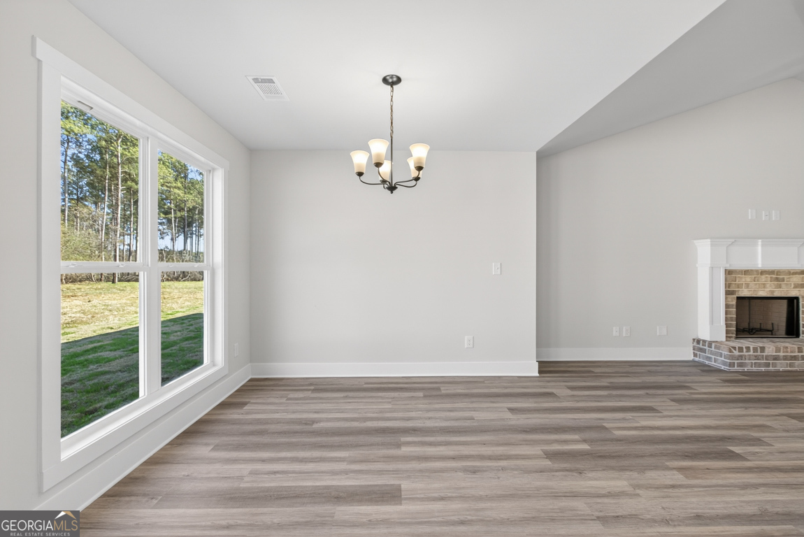 569 Liberty Hill Road, Unit 29 Hartwell, GA 30643 - Photo 18 of 46 a view of an empty room with wooden floor and a window