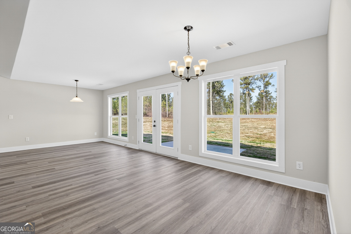 569 Liberty Hill Road, Unit 29 Hartwell, GA 30643 - Photo 20 of 46 a view of an empty room with wooden floor and a window