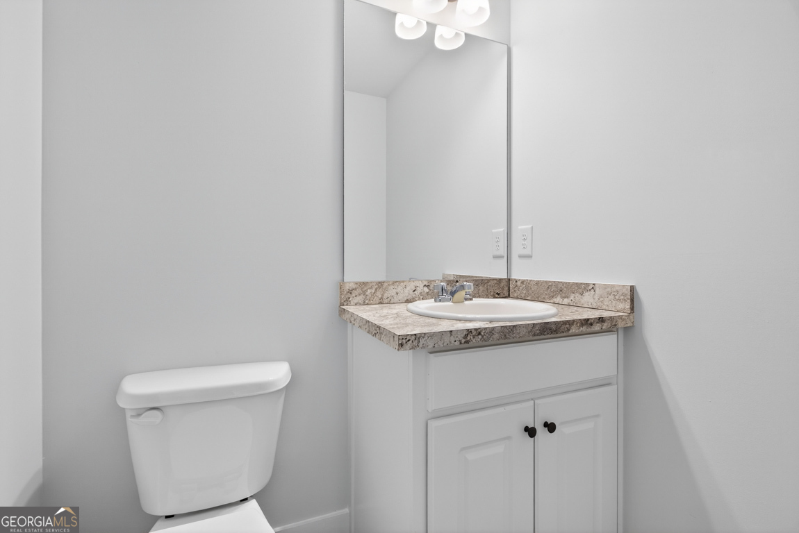 569 Liberty Hill Road, Unit 29 Hartwell, GA 30643 - Photo 22 of 46 a bathroom with a granite countertop sink and a toilet