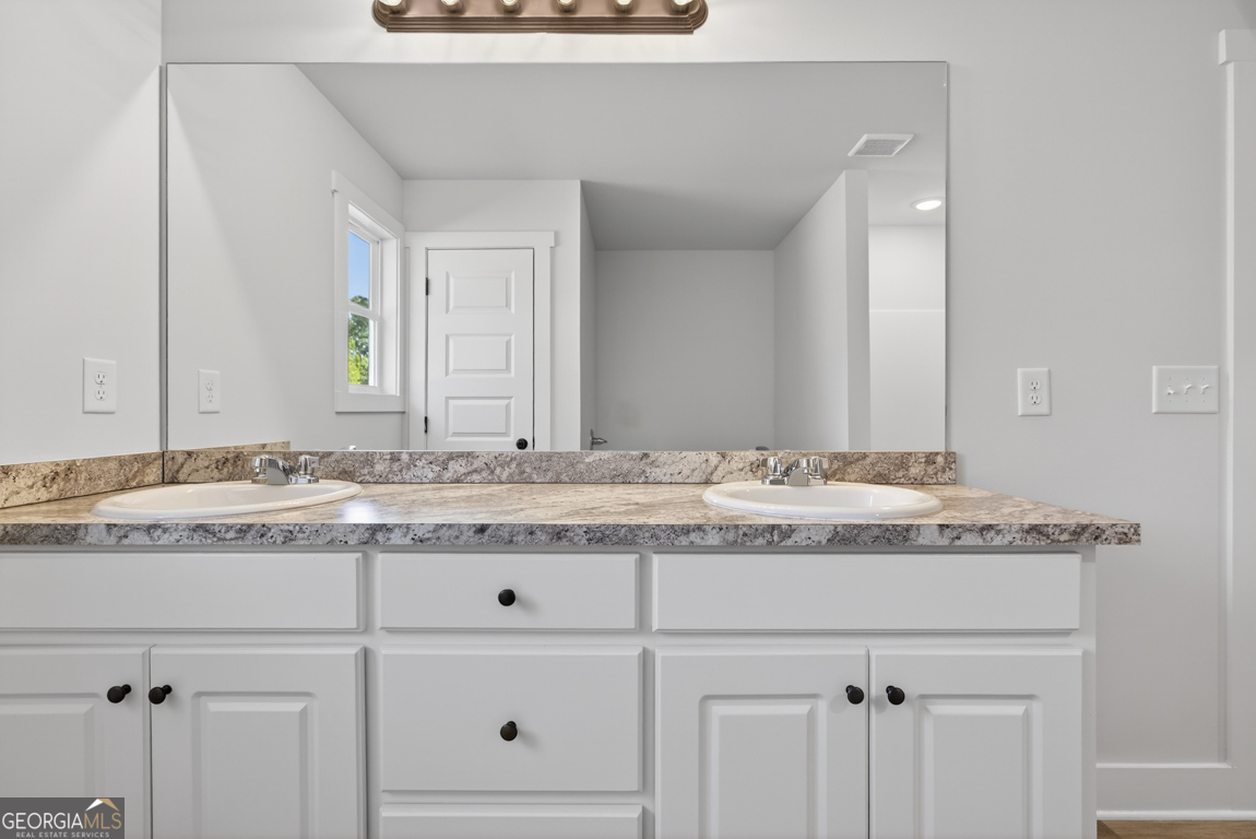 569 Liberty Hill Road, Unit 29 Hartwell, GA 30643 - Photo 41 of 46 a bathroom with a granite countertop sink and a mirror