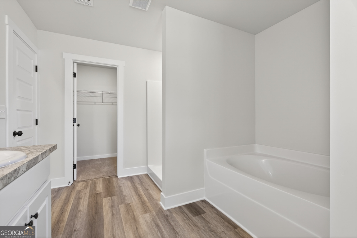 569 Liberty Hill Road, Unit 29 Hartwell, GA 30643 - Photo 42 of 46 a bathroom with a bathtub and shower