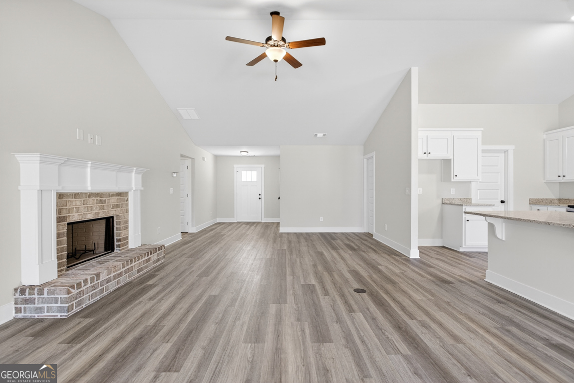 569 Liberty Hill Road, Unit 29 Hartwell, GA 30643 - Photo 5 of 46 a view of empty room with wooden floor and fireplace