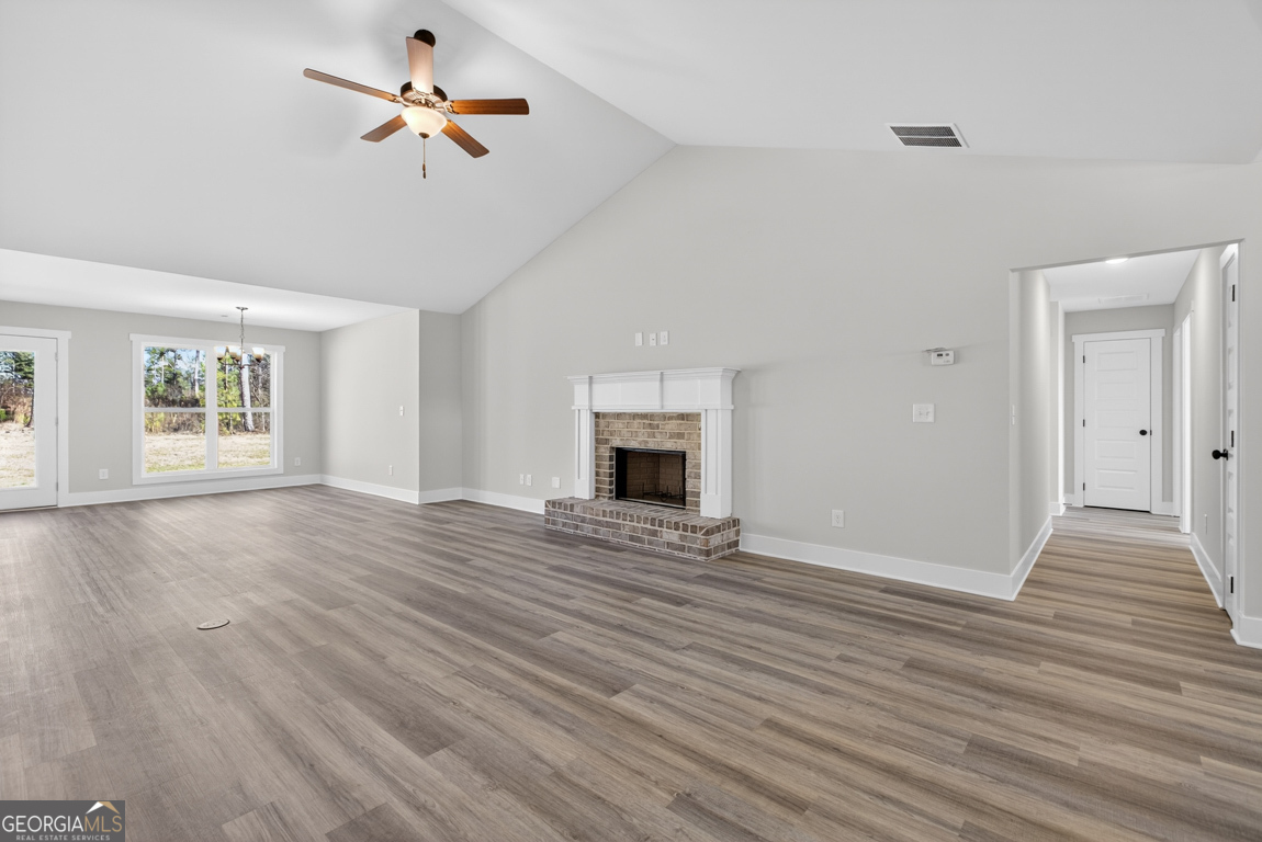 569 Liberty Hill Road, Unit 29 Hartwell, GA 30643 - Photo 7 of 46 wooden floor fireplace and windows in an empty room