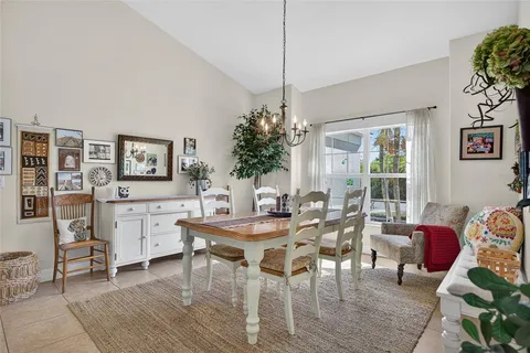 a view of a dining room with furniture and chandelier