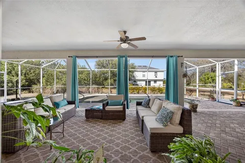 a living room with fireplace furniture and a large window