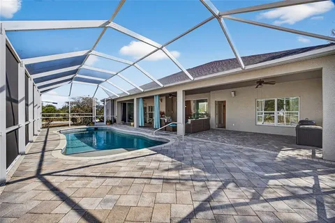 a view of a house with backyard porch and sitting area