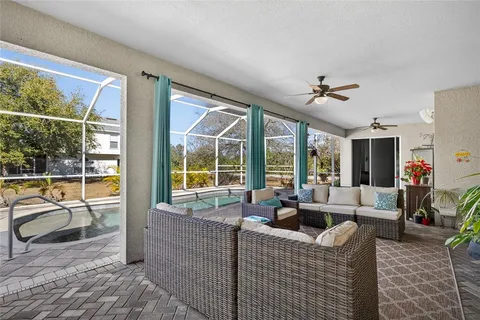 a living room with furniture and a floor to ceiling window