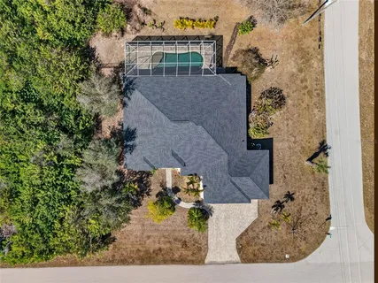 an aerial view of a house with a yard