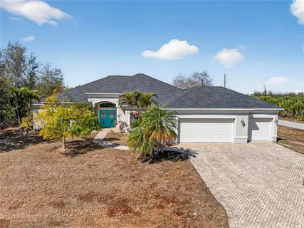 a view of a house with a yard and sitting area