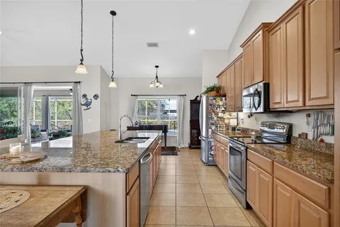 a kitchen with stainless steel appliances granite countertop a stove oven and a white cabinets