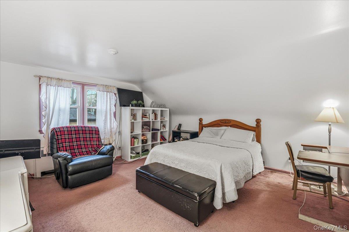 816 Pepperidge Road Westbury, NY 11590 - Photo 13 of 22 a bedroom with a bed couch and a window