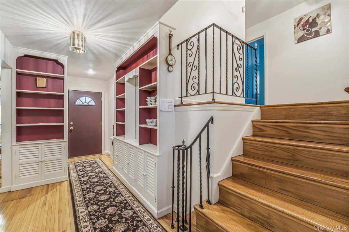 816 Pepperidge Road Westbury, NY 11590 - Photo 3 of 22 a view of stairs and an entryway with wooden floor