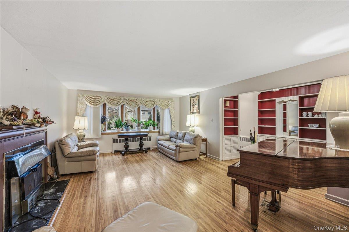 816 Pepperidge Road Westbury, NY 11590 - Photo 4 of 22 a living room with furniture and a wooden floor
