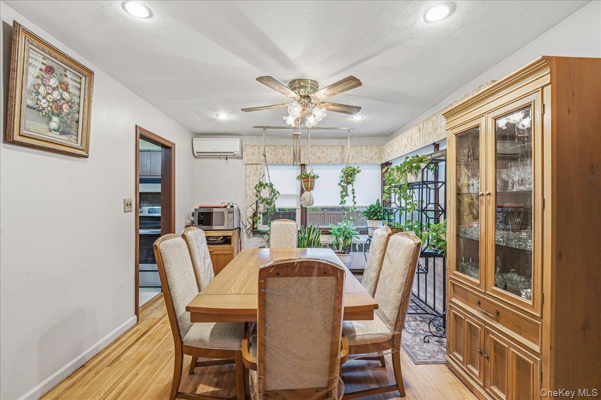 816 Pepperidge Road Westbury, NY 11590 - Photo 6 of 22 a dining room with furniture a chandelier and wooden floor