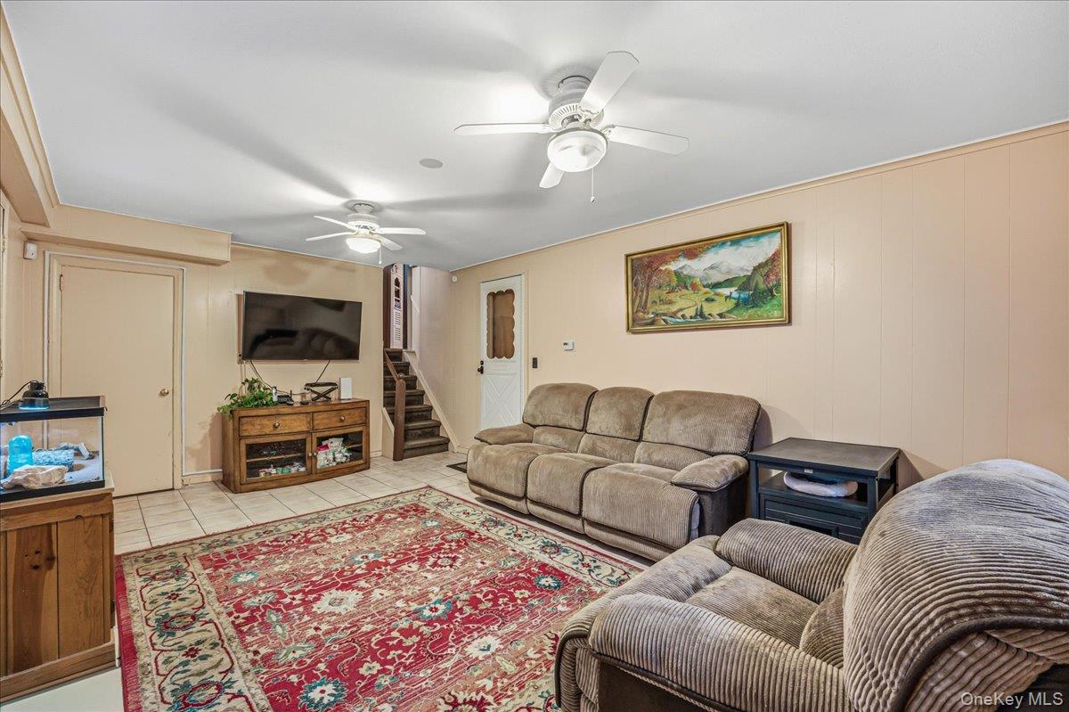 816 Pepperidge Road Westbury, NY 11590 - Photo 8 of 22 a living room with furniture and a flat screen tv