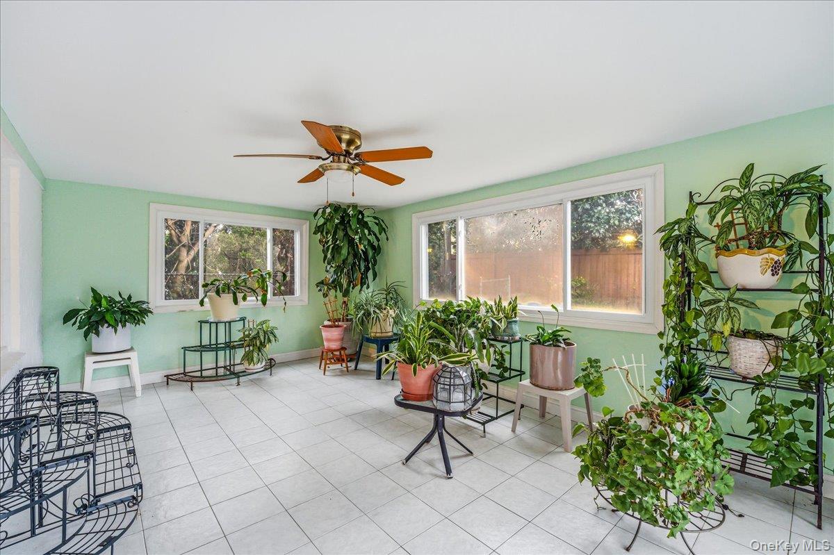 816 Pepperidge Road Westbury, NY 11590 - Photo 9 of 22 a living room filled with furniture and a potted plant
