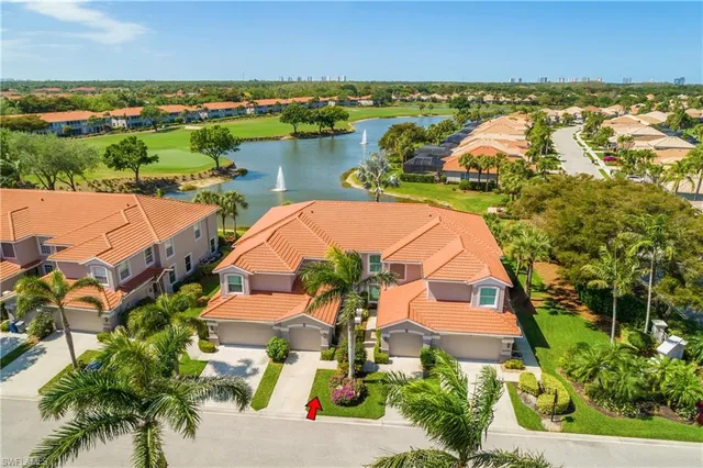 an aerial view of residential houses with outdoor space and swimming pool