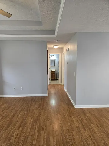 a view of a hallway with wooden floor