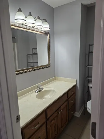 a bathroom with a sink vanity and a mirror