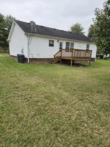a view of a house with a backyard and a patio