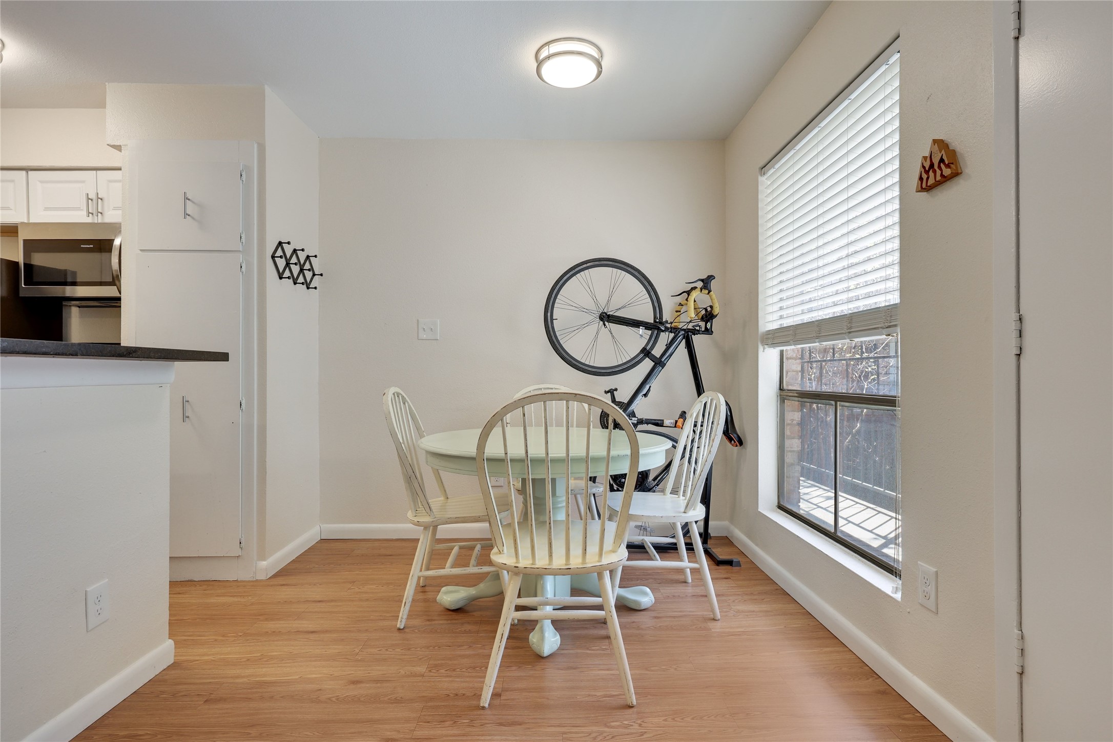 2207 Leon Street, Unit 204 Austin, TX 78705 - Photo 2 of 19 a view of a dining room with furniture window and wooden floor