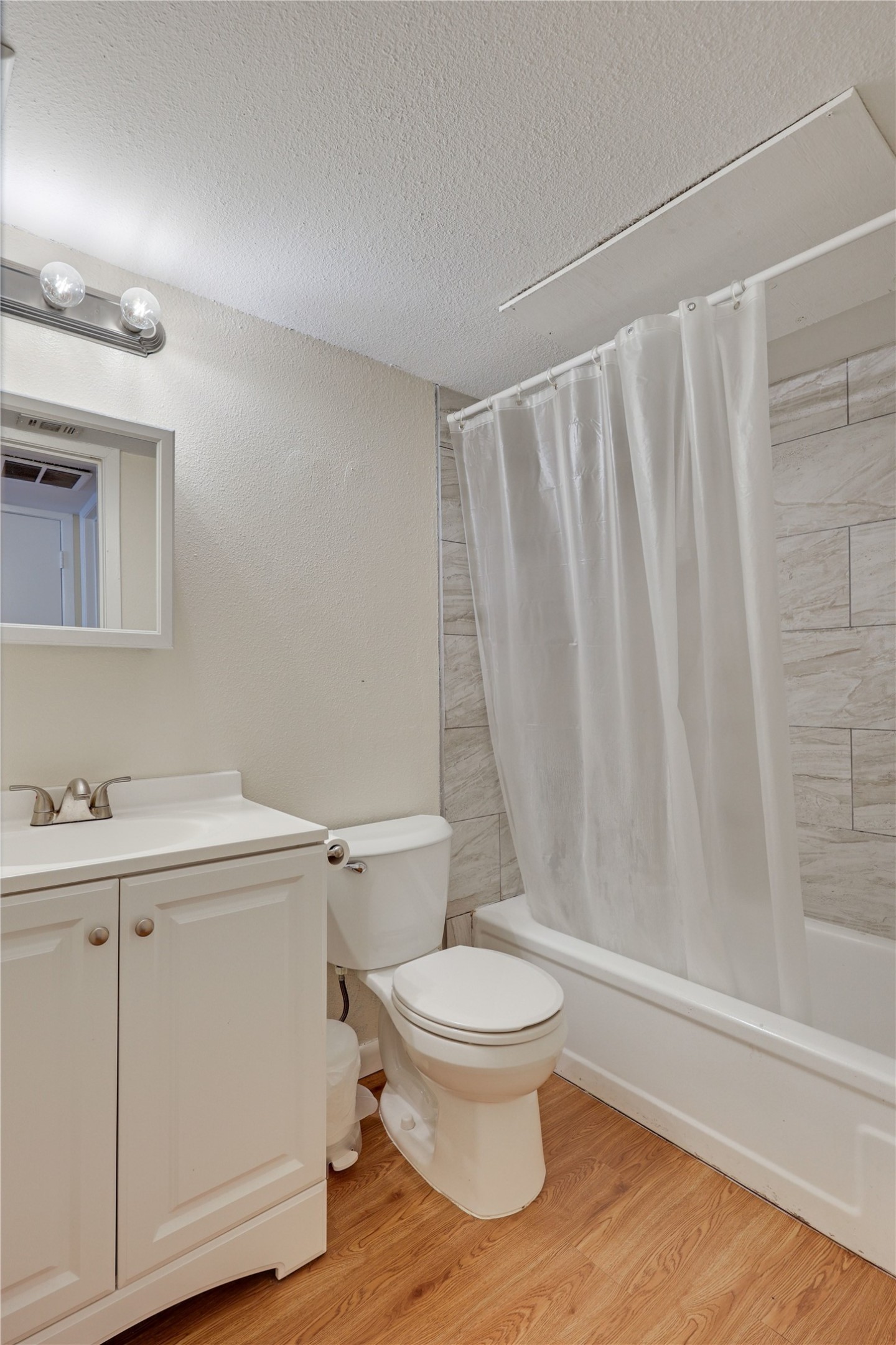 2207 Leon Street, Unit 204 Austin, TX 78705 - Photo 5 of 19 a white toilet sitting next to a bathroom sink