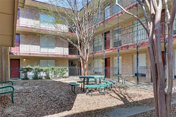 a front view of a building with garden and patio