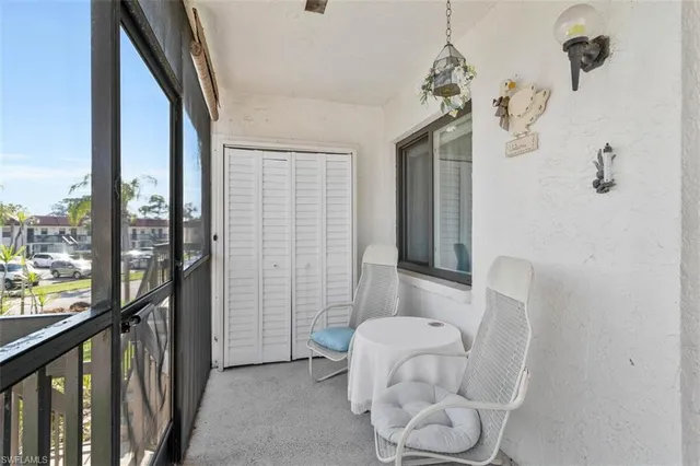 a living room with furniture a rug and a lamp