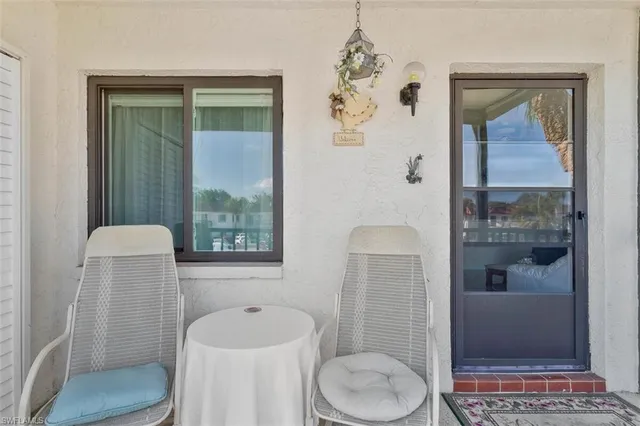 a view of a dining room with furniture and a chandelier
