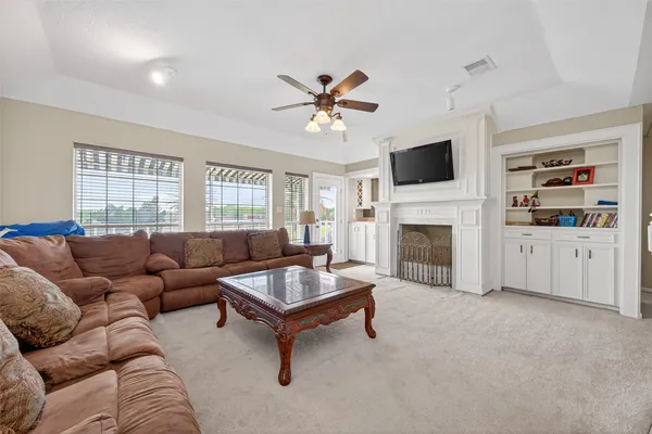 a living room with furniture a fireplace and a flat screen tv
