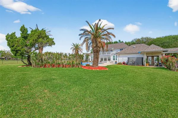 a view of a house with a backyard and a garden