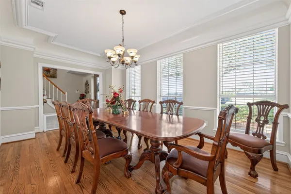 a view of a dining room with furniture wooden floor and chandelier