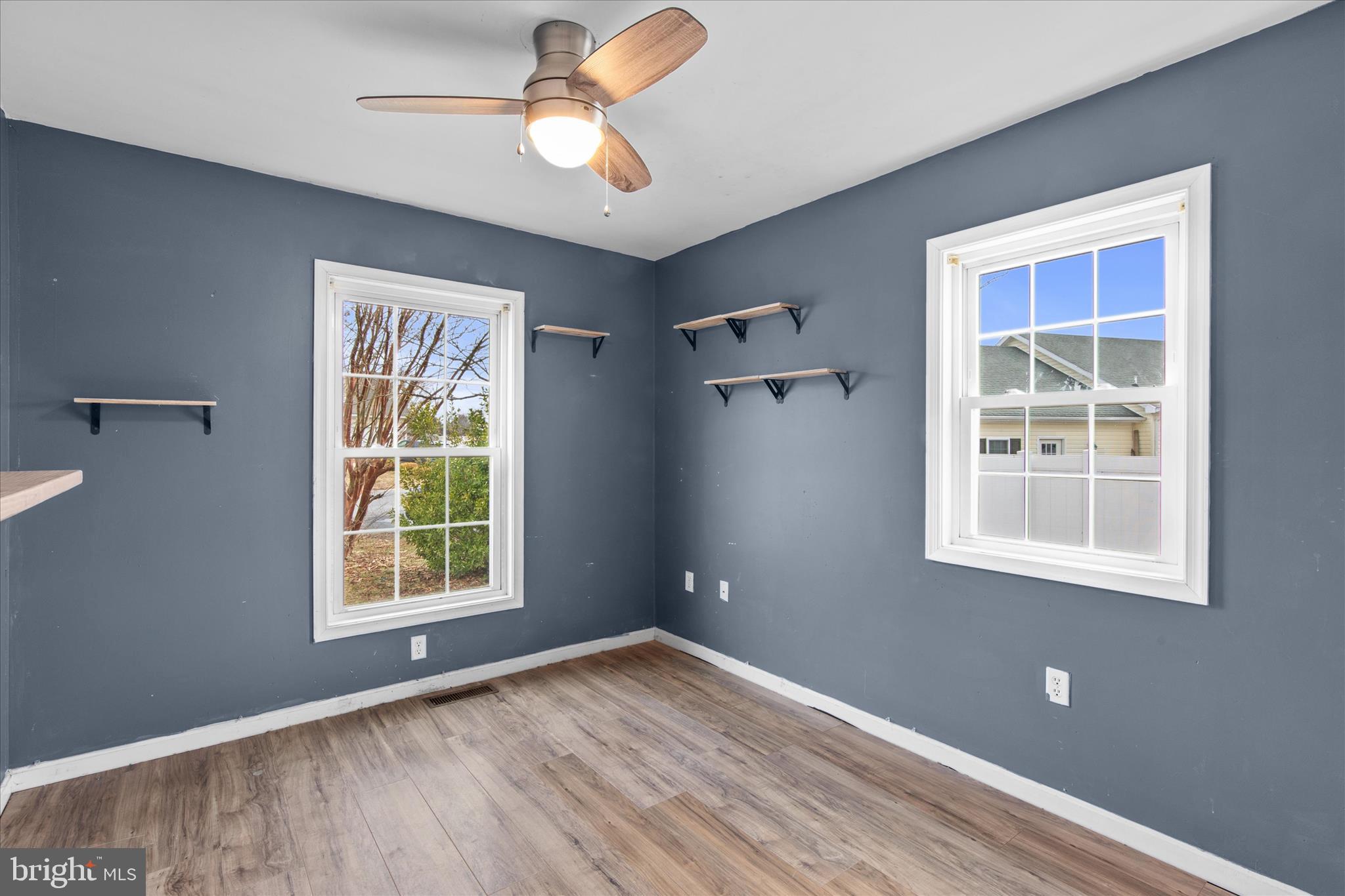 310 Autumn Ridge Drive Hebron, MD 21830 - Photo 18 of 25 an empty room with windows and fan