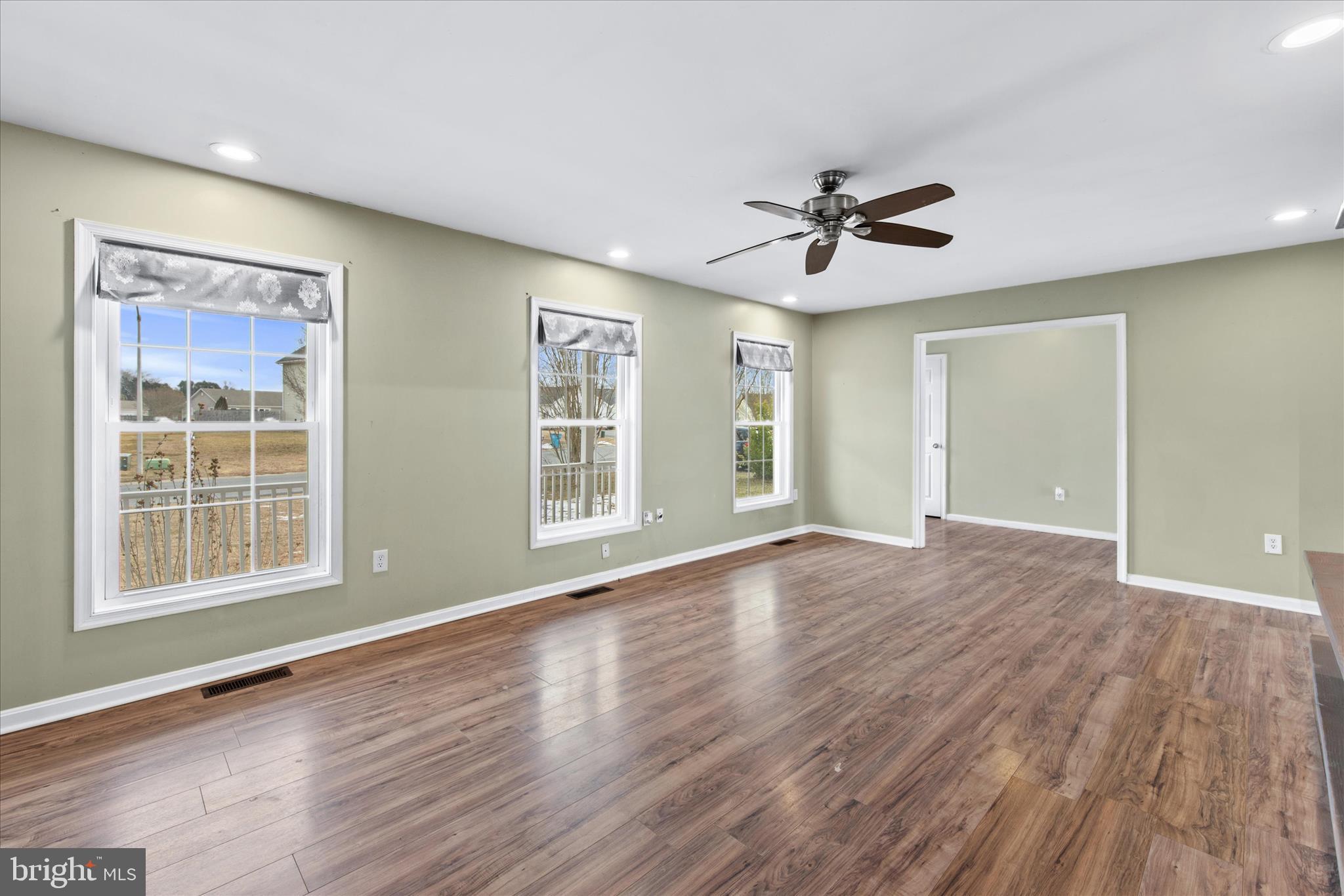 310 Autumn Ridge Drive Hebron, MD 21830 - Photo 5 of 25 a view of an empty room with a window and wooden floor