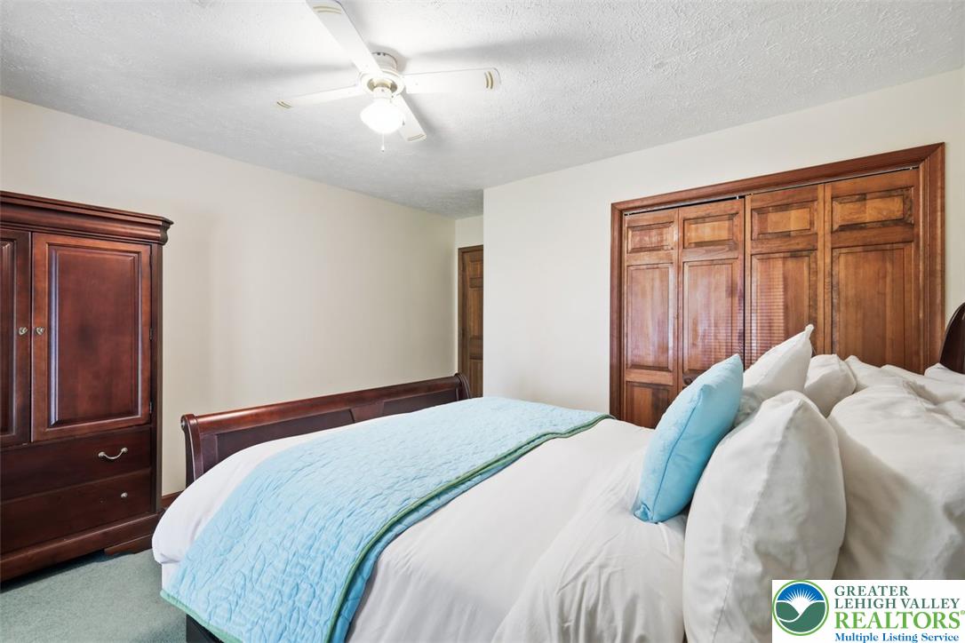 123 Meadow Road Blakeslee, PA 18610 - Photo 25 of 53 Rich wood closet doors and matching trim highlight this serene bedroom setting.
