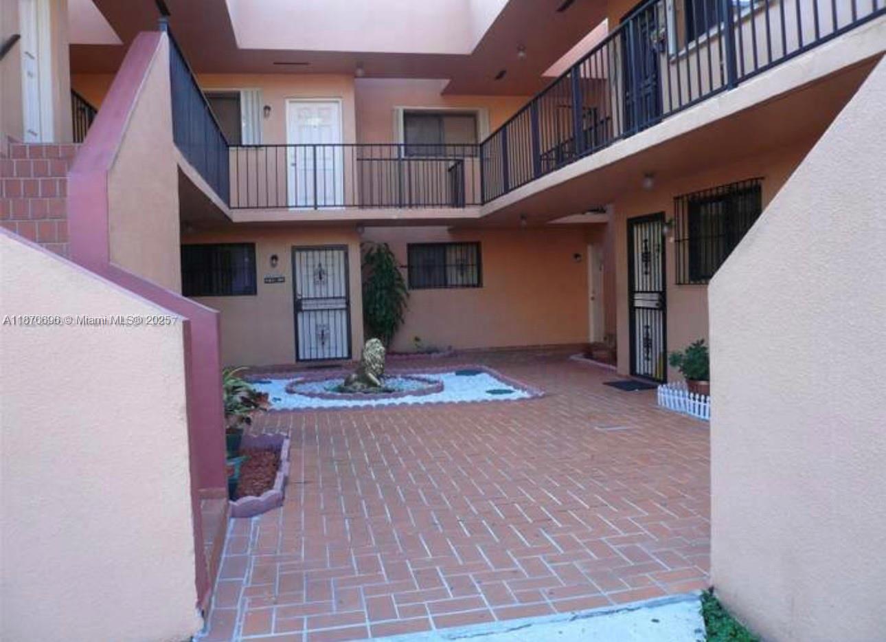 1290 West 41st Street, Unit 103 Hialeah, FL 33012 - Photo 2 of 3 a front view of a house with barbeque