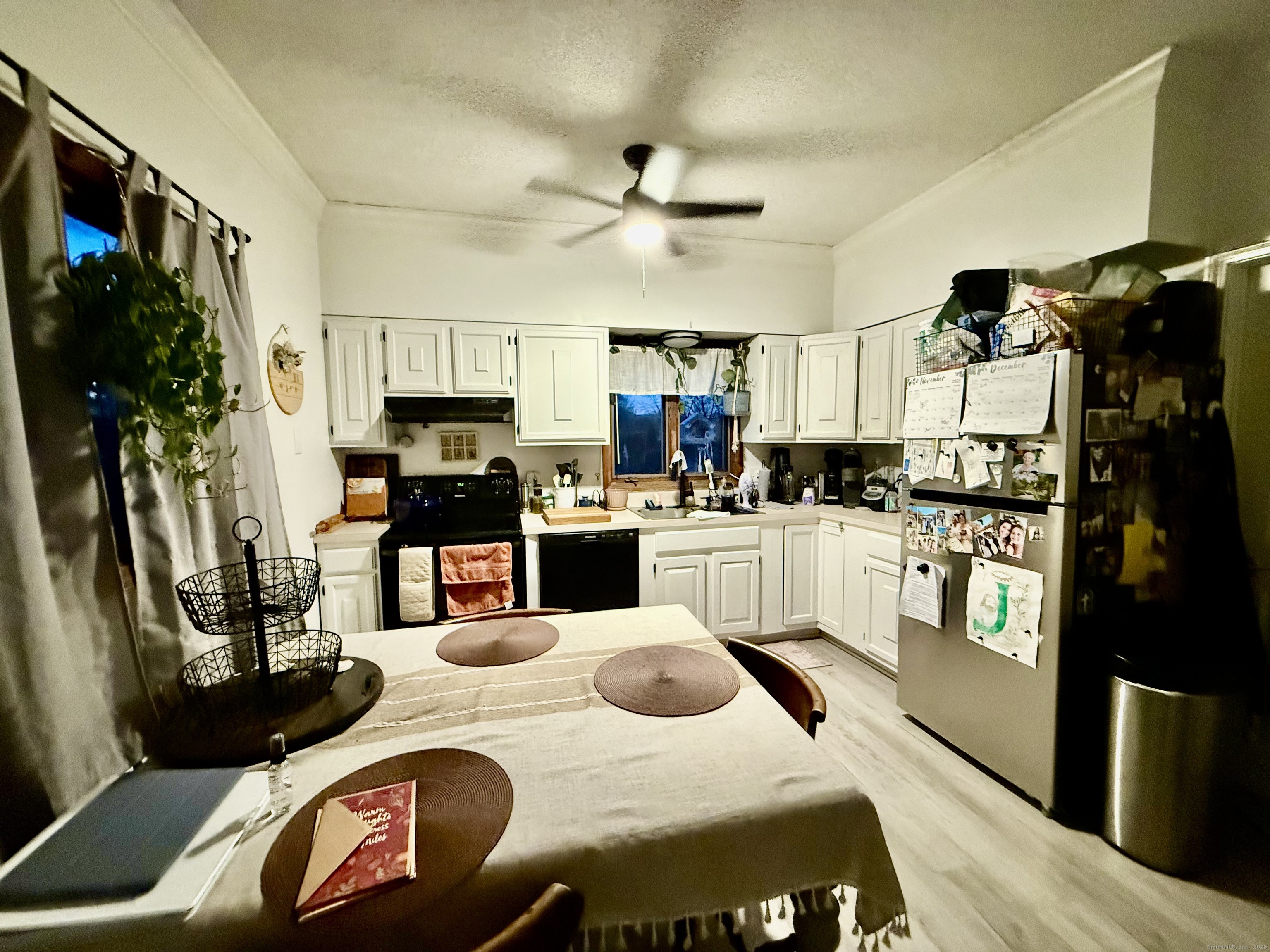 141 East High Street East Hampton, CT 06424 - Photo 9 of 17 a kitchen with stainless steel appliances kitchen island granite countertop a refrigerator a stove and white cabinets with wooden floor