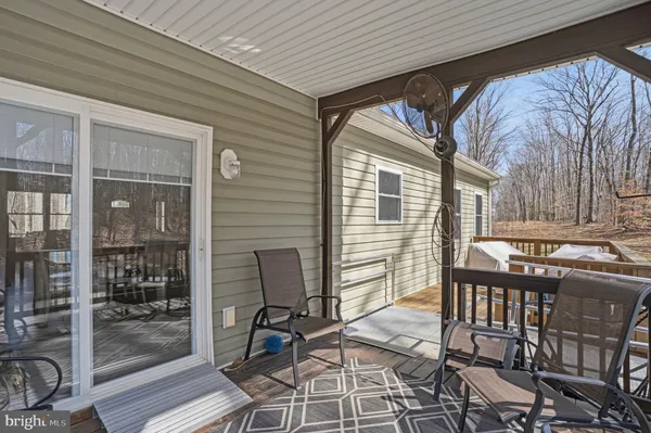 a view of a chairs and table in the balcony