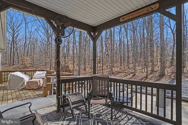 a front view of a house with a yard and car parked
