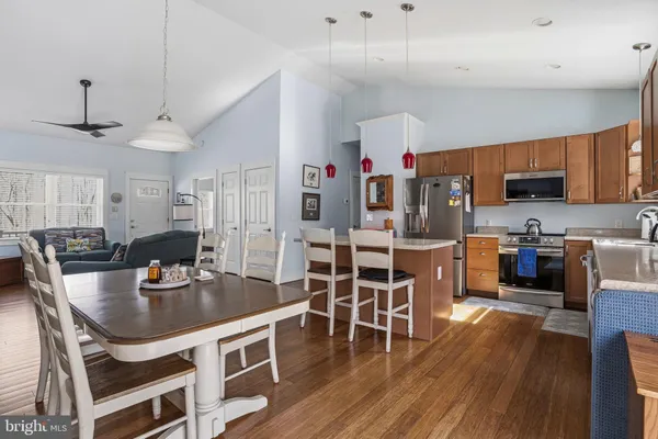 a kitchen with a sink a counter space and a dining table