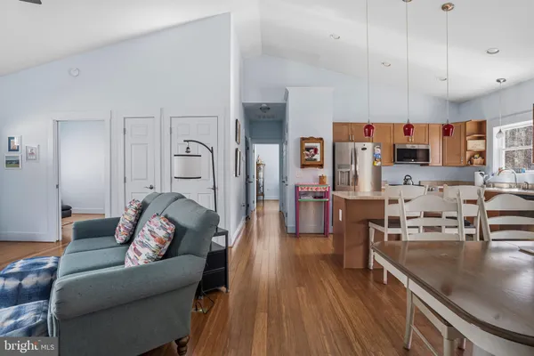 a living room with furniture kitchen view and a fireplace