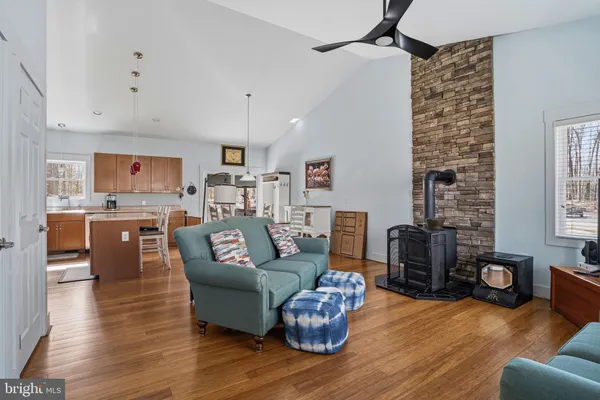 a living room with furniture kitchen view and a fireplace