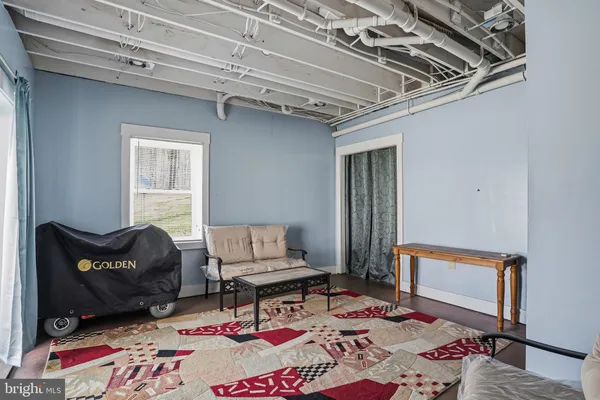 a bedroom with a bed couch and a window